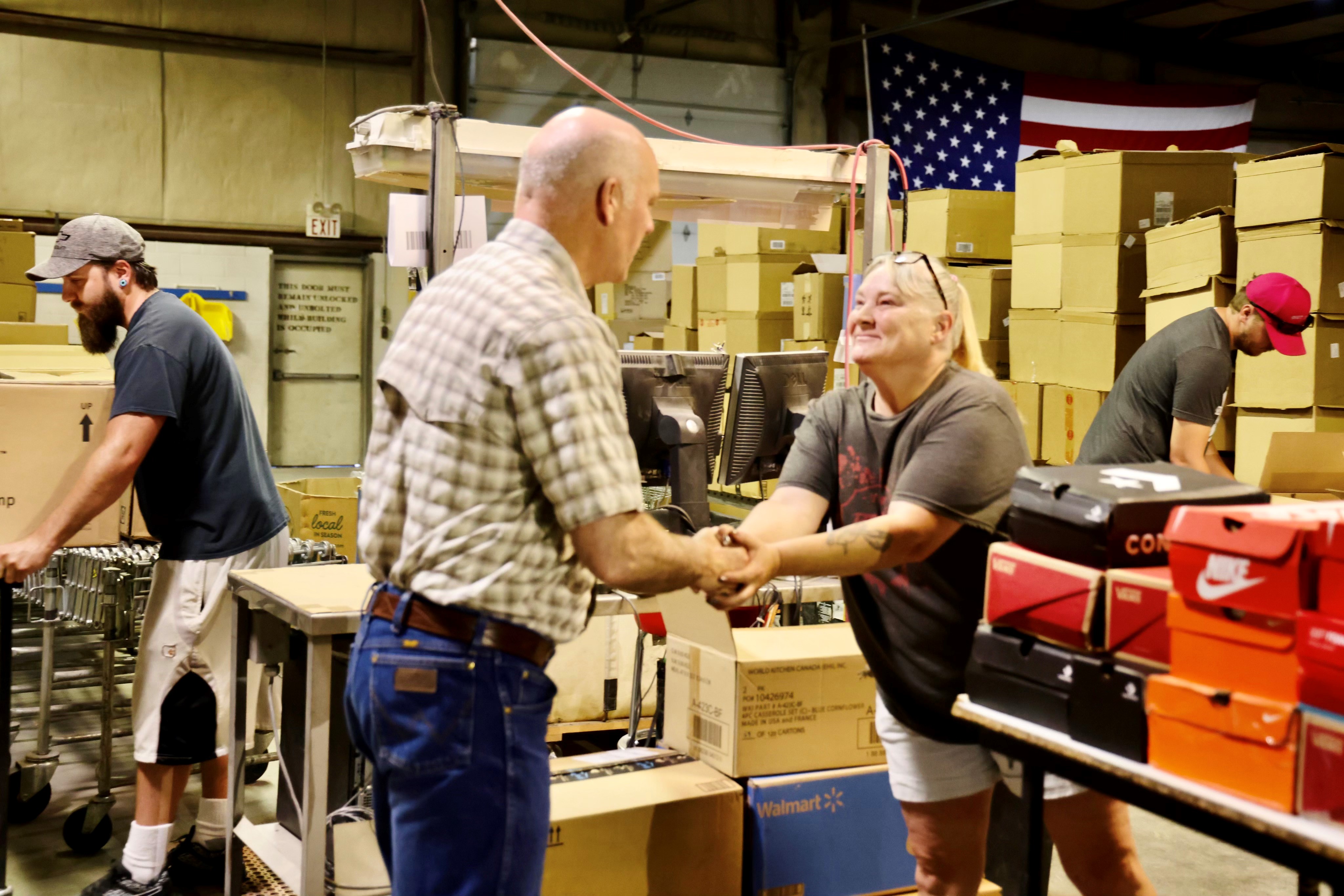 Gov. Gianforte greeting an employee at Selltec Prep, a prep-and-ship center, in Roundup in July 2021